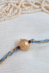Gold Plated Rakhi With Blue Threads With Chandan Beads